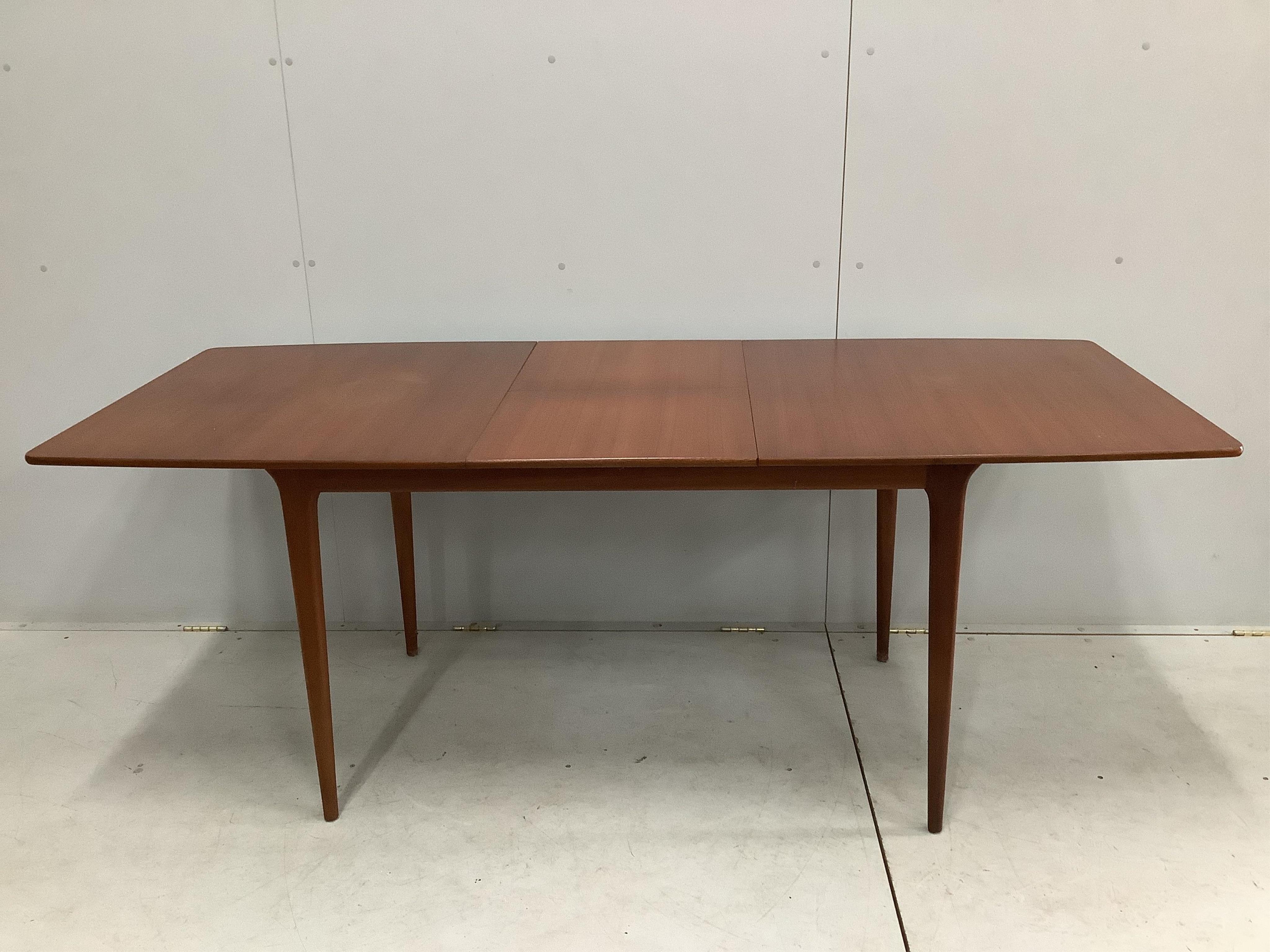 A mid century McIntosh teak extending dining table, width 150cm, depth 82cm, height 74cm together with four chairs, and a low sideboard. Condition - fair to good